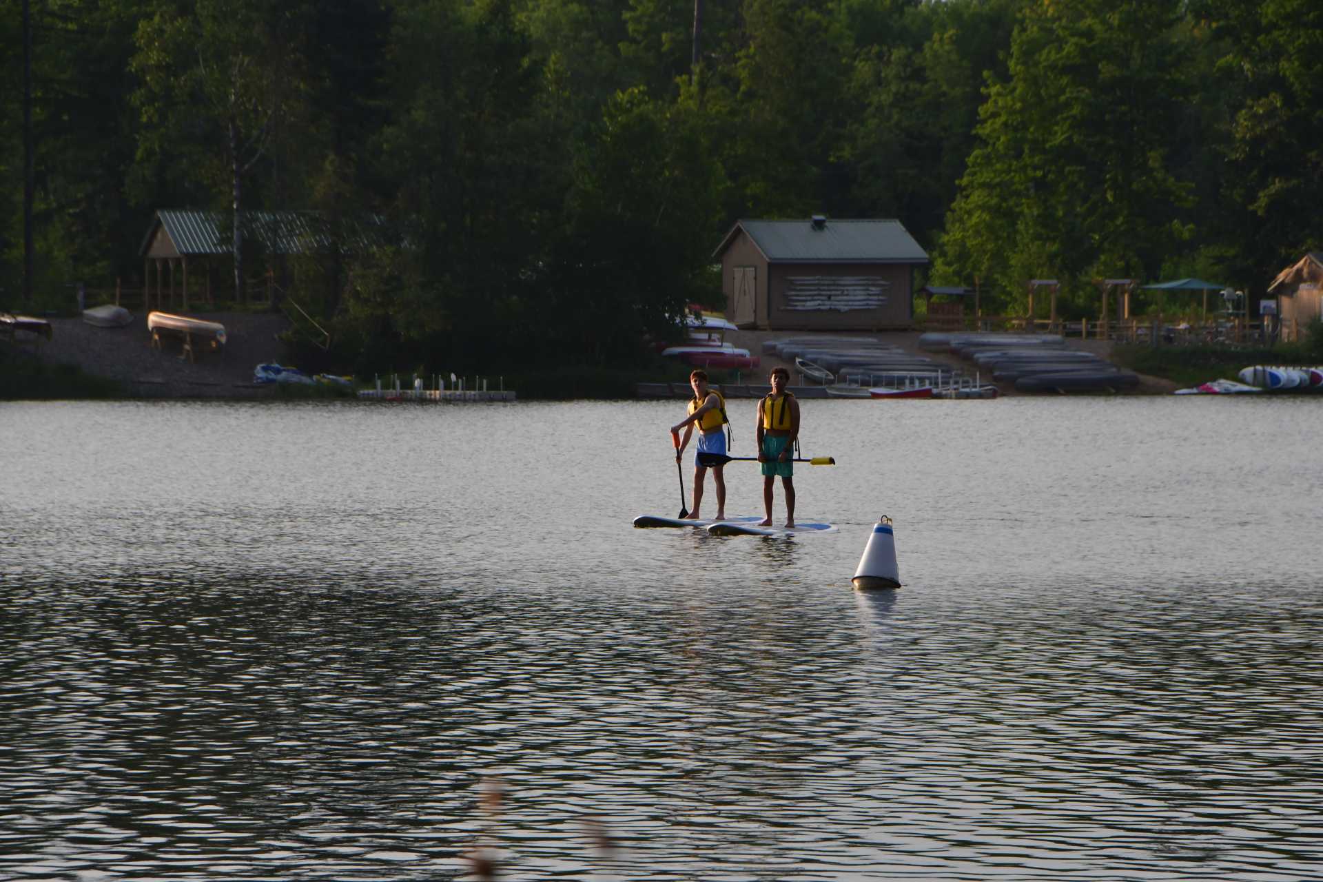 Two people doing watersports on the lake at Camp MaKaJaWan