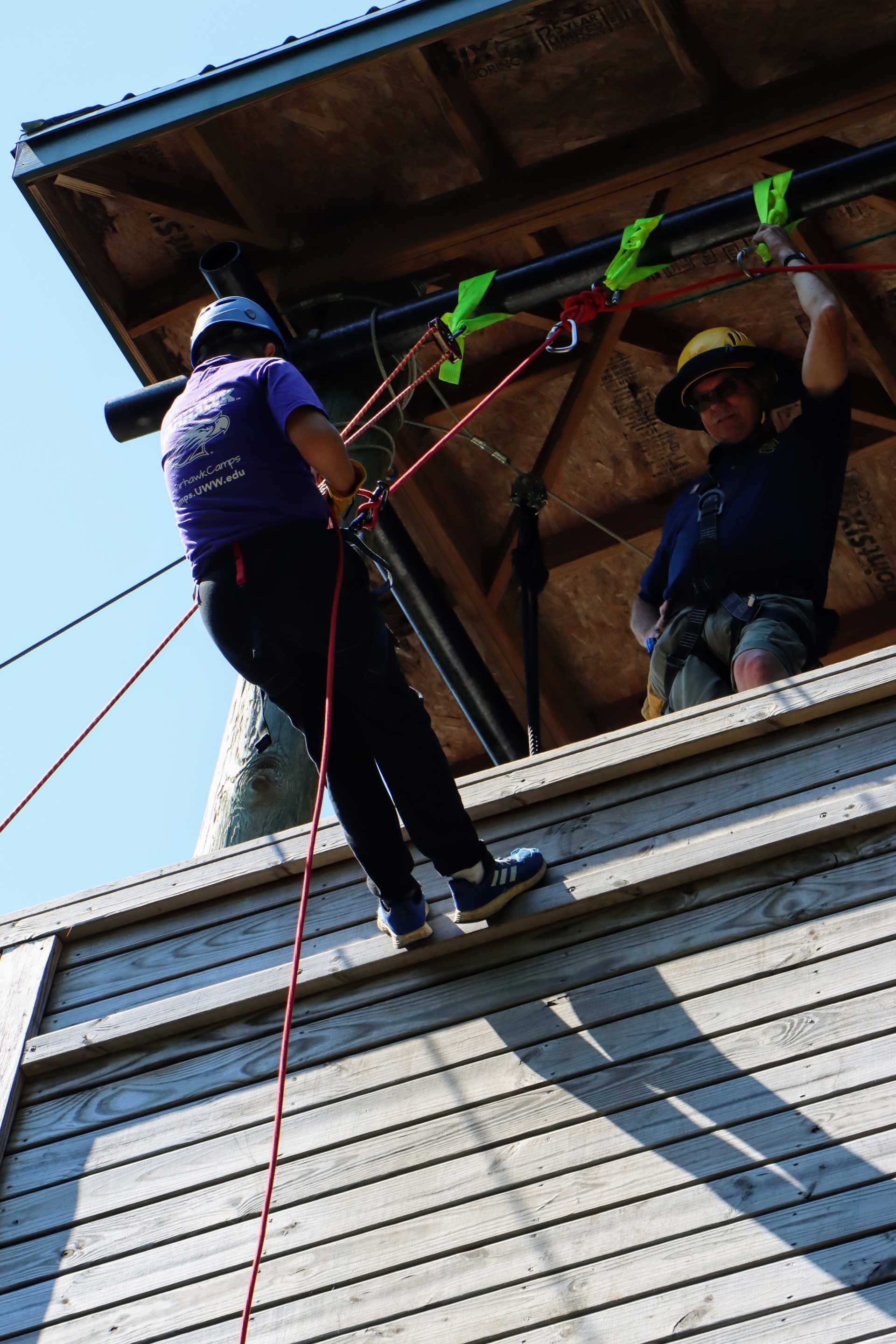 A scout rappels down the wall