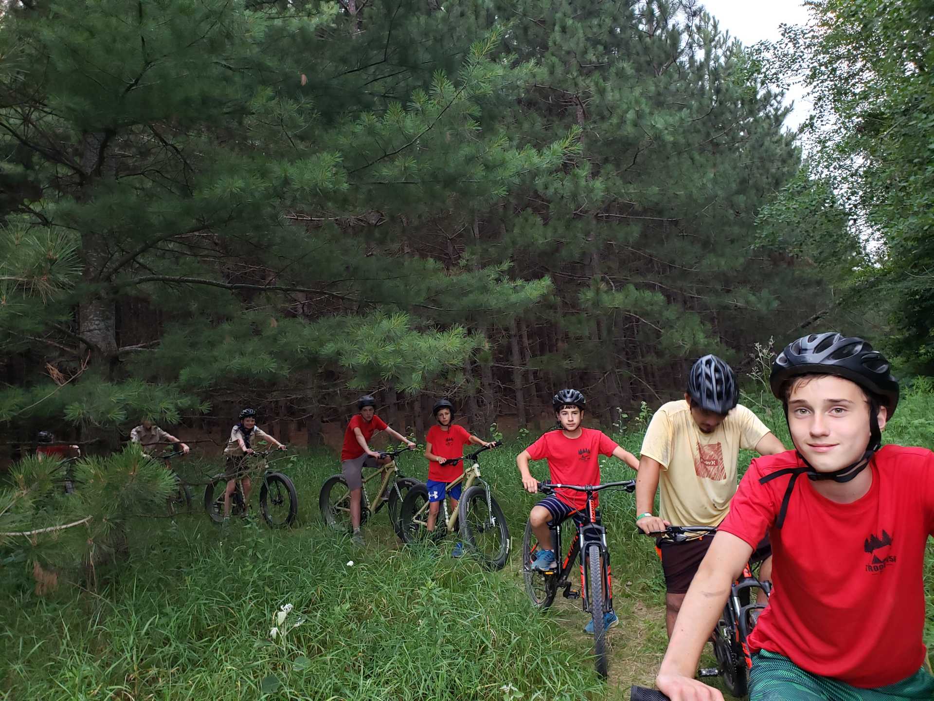 Scouts on bikes make a formation and smile at the camera