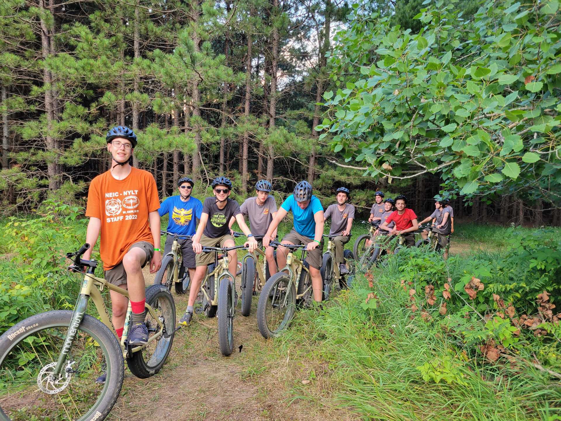 Scouts on bikes line up on a trail